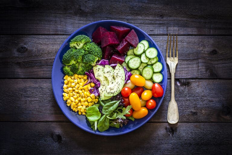Colourful balanced meal with vegetables, grains, and protein arranged on a ceramic plate